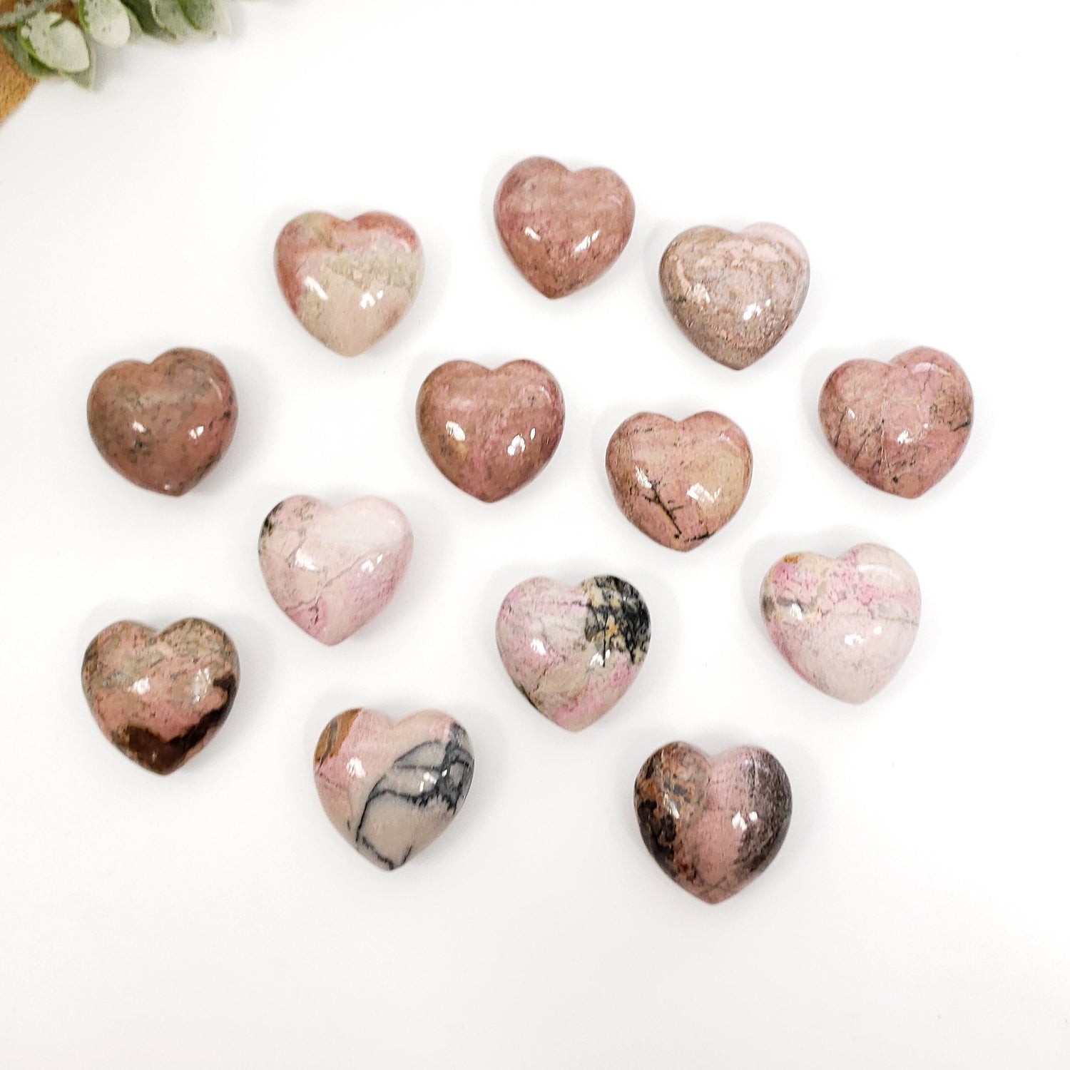 Heart-shaped marbled stones on a white background