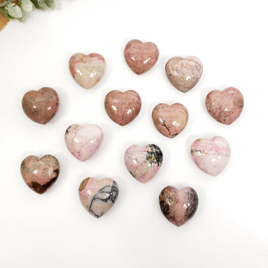 Heart-shaped marbled stones on a white background