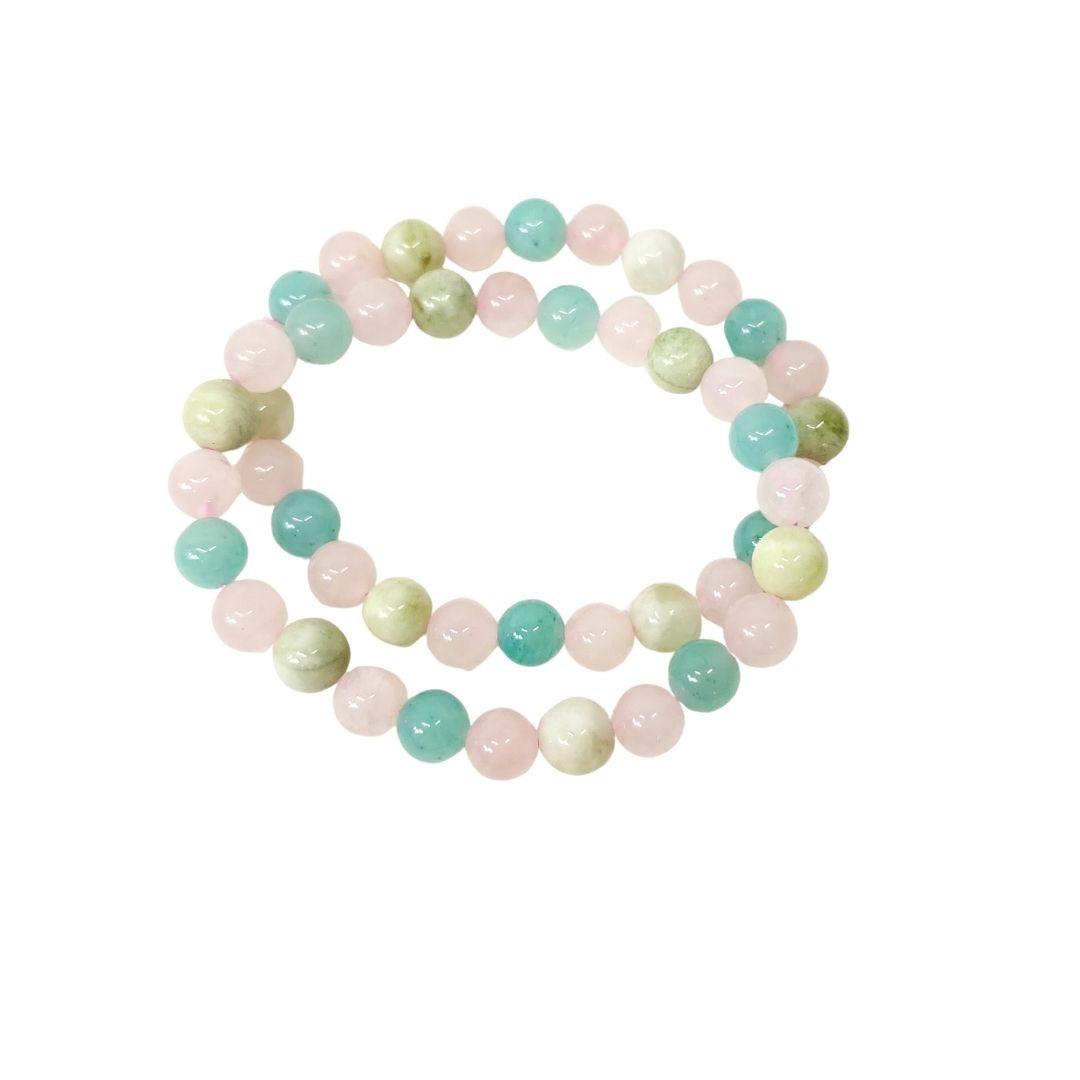 Two Amazonite, Jade and Rose Quartz crystal beaded stretch bracelet made of polished round gemstone beads in pastel pink, mint green, and pale yellow-green, arranged in a circle on a plain white background.