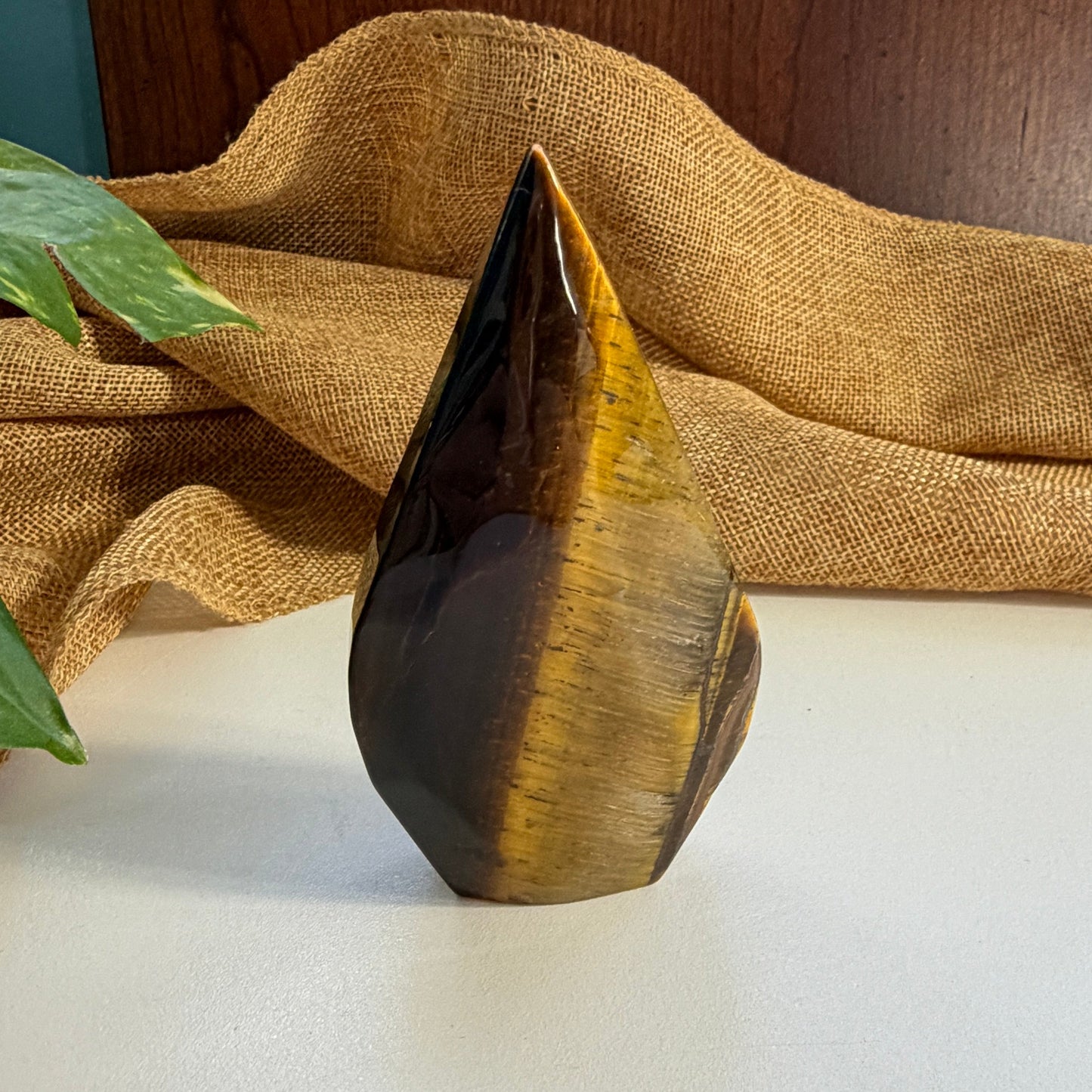 Close-up of Golden Tiger Eye Flame crystal texture revealing natural chatoyancy and warm brown-gold banding patterns