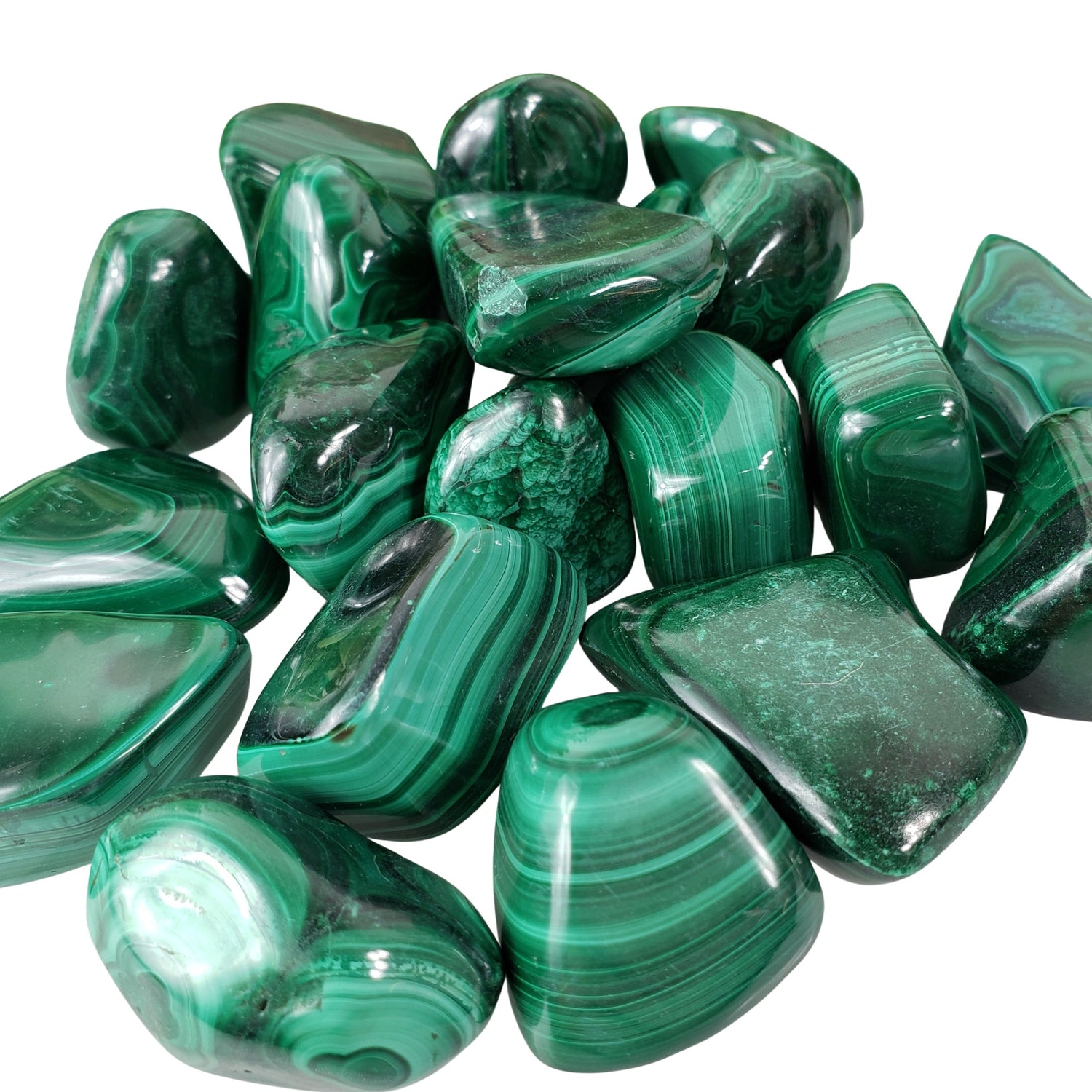 Tumbled Malachite gemstones placed on a white background, perfect for meditation or intention setting.